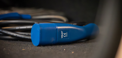 Blue Voldt Type 2 EV charging cable coiled up on the ground