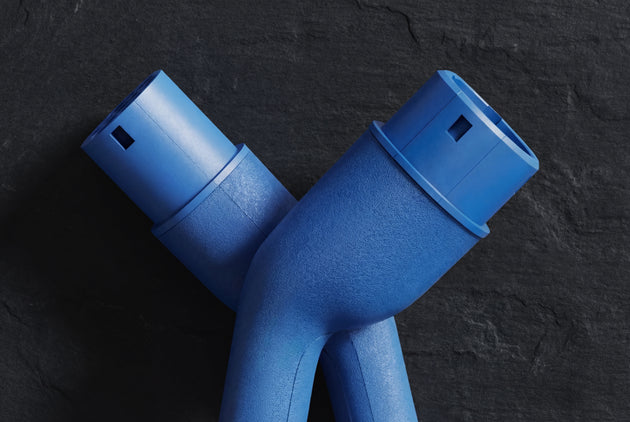 Blue Type 2 male and female connectors of a Voldt charging cable on dark slate