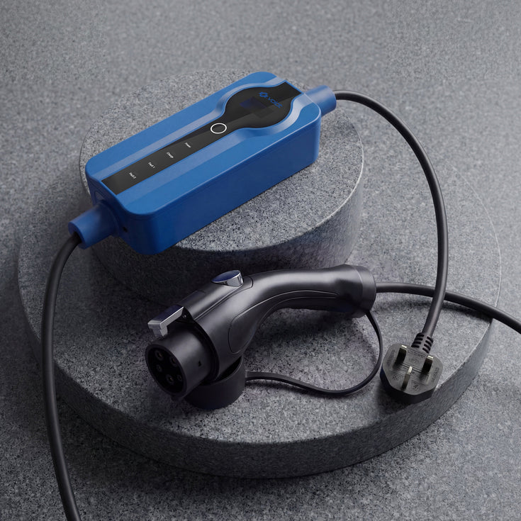 Voldt® Type 1 Portable Charger with UK three-pin plug on a dark stone surface