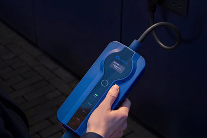 Hand holding the control box of the Voldt® Type 1 Portable Charger while charging