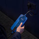 Hand holding the control box of the Voldt® Type 1 Portable Charger while charging